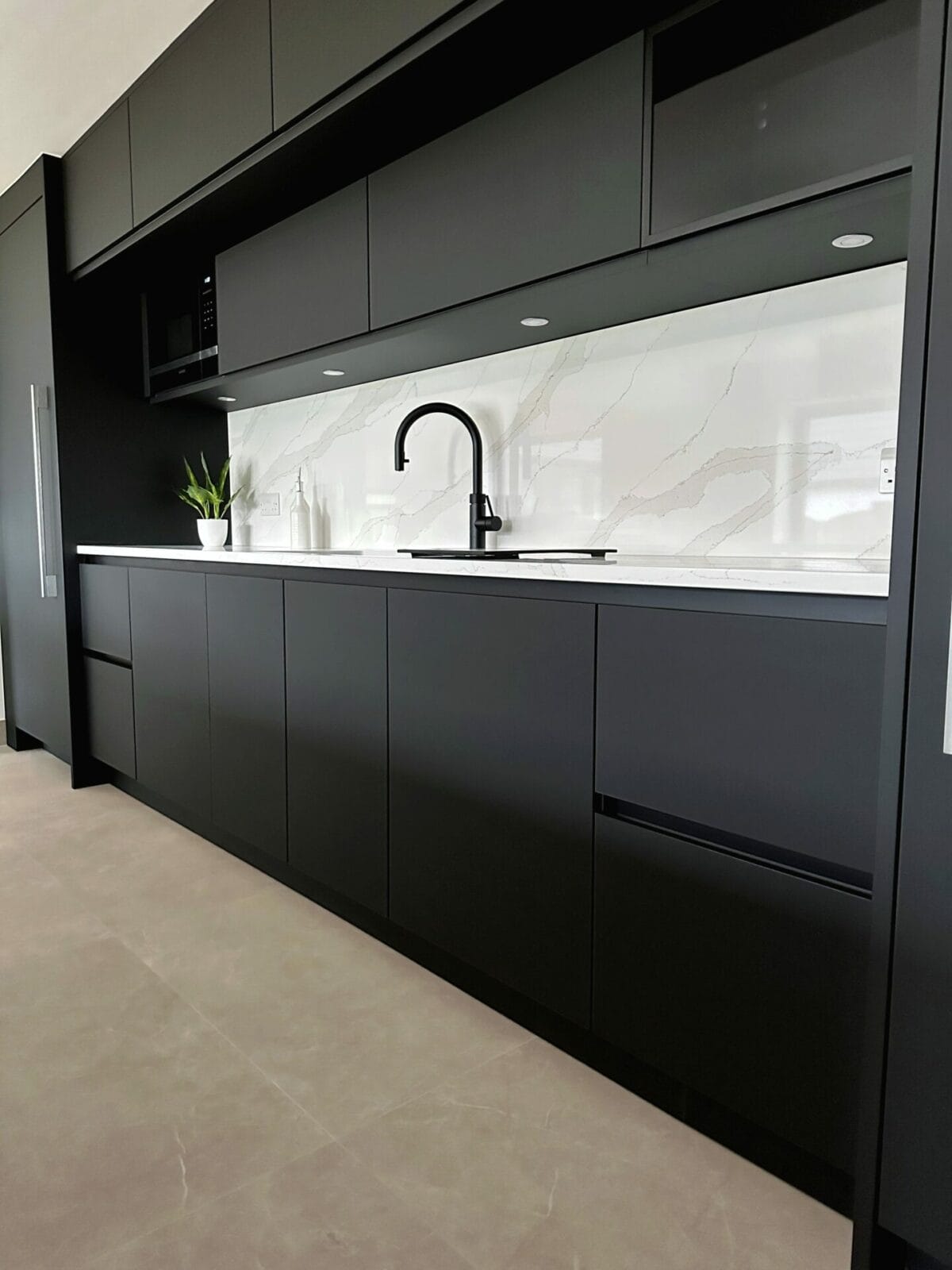 Black handless kitchen by Mike Hughes Fitted Interiors sink view edited